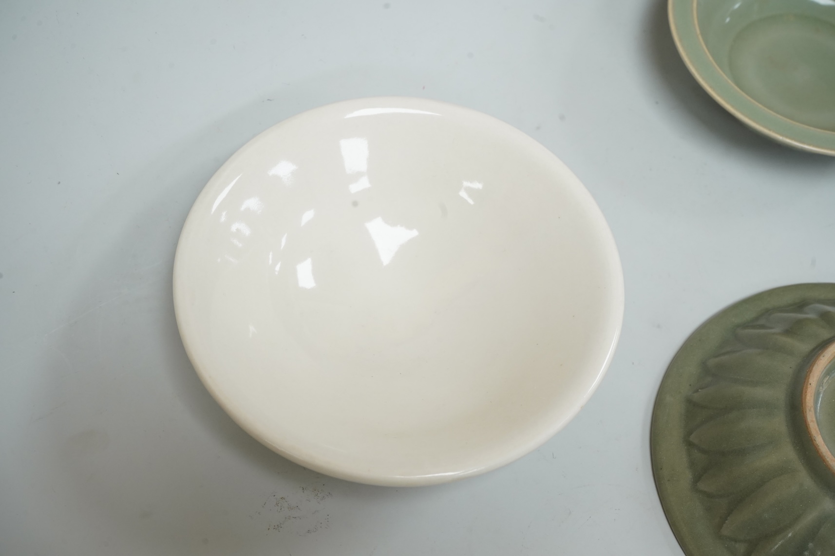 A Chinese celadon glazed twin fish dish, another similar and a white glazed bowl, largest 13.5cm